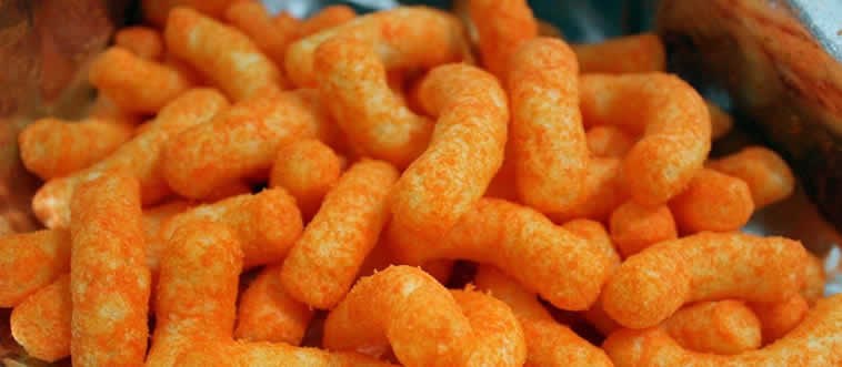 This vintage aesthetic paired a rugged cowboy mascot with airy, cheese-flavored spheres. Which snack set that iconic style trend?