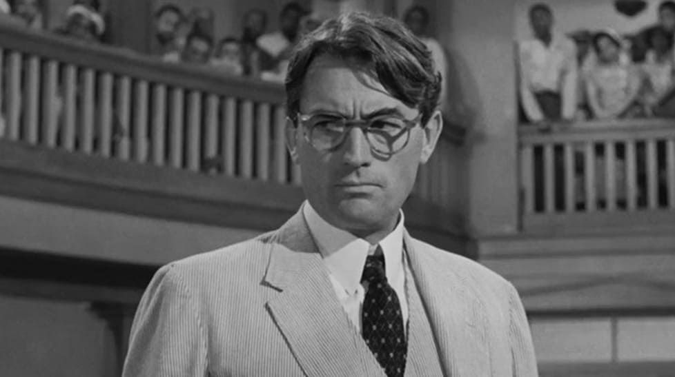 Frame this classic Southern silhouette: Atticus Finch commands the room in To Kill a Mockingbird. What is his exact profession?